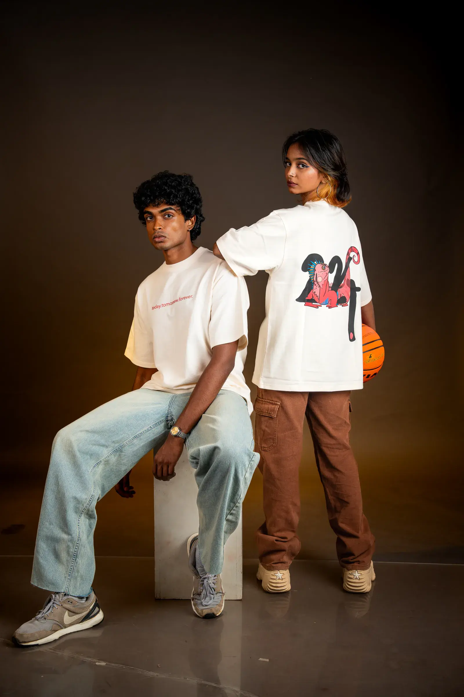 Two models wearing oversized cream 224dot graphic tees